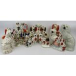A large group of Staffordshire ceramic figures. Comprising a wide variety of King Charles Spaniels
