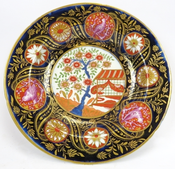 An English Imari profusely decorated bowl, 19th century. Overglaze painted with a Chinese garden
