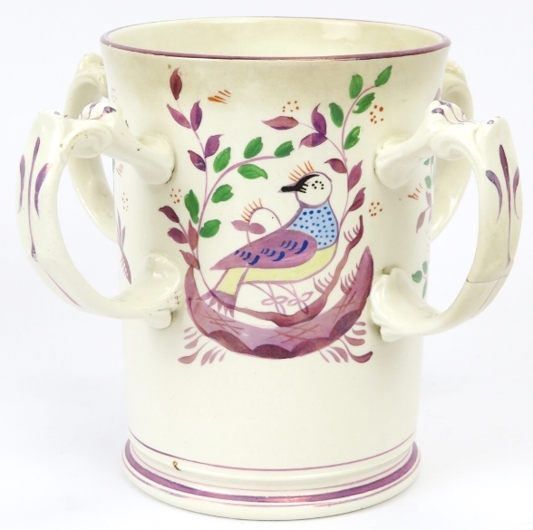 A rare Victorian lustreware four handled tankard, late 19th century. The cylindrical body