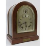 A mahogany and glass table clock, early 20th century. With polished steel Roman numeral dial.