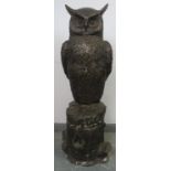 A very large bronzed metal statue of a long eared owl, 20th century. Depicted standing perched on