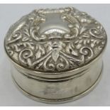 A silver trinket box in the Victorian style, embossed with mask, birds & scrolls, black velvet