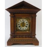 Junghans mantle clock. Architectural oak case, coil strike, with key included. Bevelled glazed