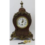 A French boulle work mantle clock, 19th century. The wooden case with black lacquered sides and