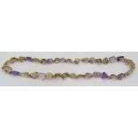An amethyst & citrine laser cut necklace interspersed with small yellow metal beads, 14ct gold