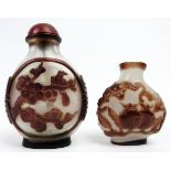Two Chinese overlay glass snuff bottles, late 19th/early 20th century. Both of ovoid form with