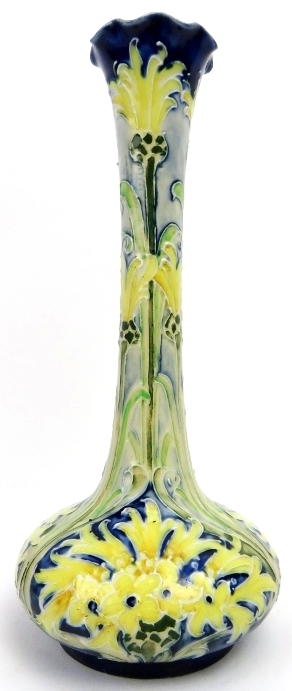 A William Moorcroft Macintyre Florian Ware cornflower pattern vase. Modelled with a the tall slender