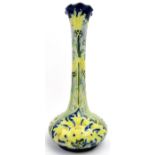 A William Moorcroft Macintyre Florian Ware cornflower pattern vase. Modelled with a the tall slender