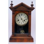 - A European carved walnut mantle clock, 19th/early 20th century. With Neoclassical elements. Key