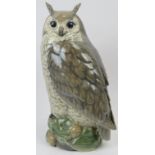 A large Royal Copenhagen model of a long eared owl. Modelled on a naturalistic base with pine cones.