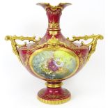 A European twin handled floral and gilt decorated vase, 19th century. Probably German