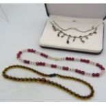 A ruby & rose quartz necklace interspersed with small yellow metal beads on a 14ct yellow gold