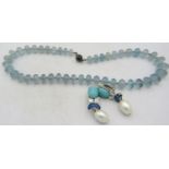 A graduated aquamarine bead necklace with yellow metal clasp. Largest bead approx 12mm x 8mm,