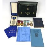 A collection of Masonic items. Including two enamelled silver gilt medals, a silver medal of oval