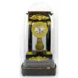 A French ebonised and ormolu mounted Portico clock, 19th century. With four tapered columns, the