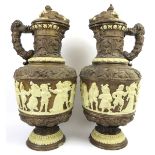 A large pair of German relief moulded ewers and covers, 19th century. Profusely decorated in high