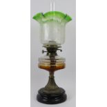 A large Victorian brass and coloured glass oil lamp. Supported on a ceramic base. 22 in (56 cm)