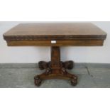 A Victorian rosewood turnover card table with inset green baize, on a tapering octagonal column