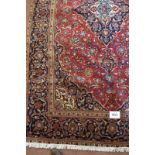 Central Persian Kashan carpet central motif depicting foliage blue on red ground 300cm x 185cm (