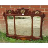 A Georgian mahogany parcel gilt triptych bevelled wall mirror, within a shaped surround featuring
