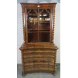 A 19th century Continental flame mahogany glazed display cabinet, featuring barley twist