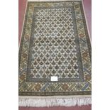 A 20th century wool rug, Persian design. 220cm x 130cm (approx). Condition report: In very good