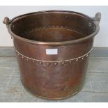 A 19th century riveted and banded copper log bin, with steel handle. H35cm Diameter 40cm (approx).