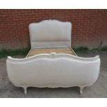 A vintage French kingsize double bed, the carved frame painted distressed grey, with padded head and