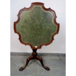 A 19th century mahogany shaped-edge tilt-top table, on a tapering spiral carved column with