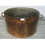 A large 19th century copper jam pan, with handles to either side. Would serve as an ideal log bin.