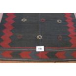 North East Persian Sofreh rug. 9 small motifs on a black field bordering in red. 136cm x 131cm (