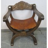 A vintage mahogany X-frame ‘Savanorola’ chair, the back carved with a heraldic crest, the heavy