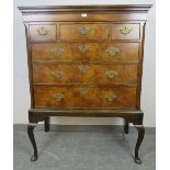 A Georgian walnut chest on stand, housing three short over three long graduated cock-beaded