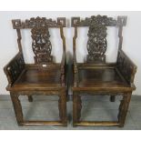 A pair of early 20th century Chinese armchairs in the 19th century style, with ornately carved and
