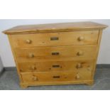 An antique pine French chest of four long drawers with turned wooden knob handles, on bracket