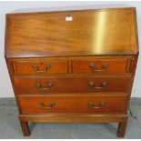 A mid-century teak bureau by Gordon Russell, the cross-banded fall front opening onto filled shelves