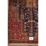 North West Persian Hamadan rug square central motif on blue ground and deep red borders. In good