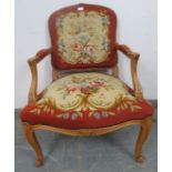 A vintage French oak open-sided armchair in the Louis XV taste, with acanthus carved arms,
