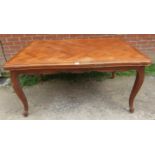 A vintage French walnut draw-leaf extending dining table, the shaped top with parquetry inlay, on