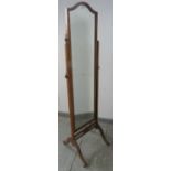 An Edwardian mahogany cheval mirror with turned finials, on splayed supports with small brass