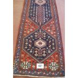 A fine South West Persian Abadeh runner blue on terracotta field. In good condition. 295cm x 75cm (