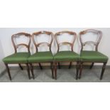 A set of four Victorian rosewood balloon back dining chairs with green upholstery, on tapering