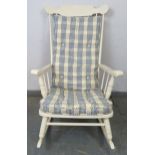 An American style rocking chair painted white, with sprung seat and loose seat squab cushion