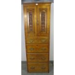 An Edwardian satin walnut linen press of small and narrow proportions, the panelled doors, relief