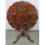A George III mahogany ‘birdcage’ supper table, the top having moulded plate wells divided by shell