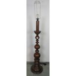 A vintage hardwood standard lamp with bulbous turned column, on a circular plinth base. Includes
