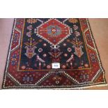 Central Persian Bakhtiar rug. Central panel with 3 motifs on terracotta field, 285cm x 135cm (