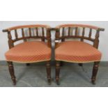 A pair of 19th century oak tub chairs, upholstered in red and gold patterned material, on fluted