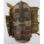 Tribal Art: An African carved and painted mask, probably Ghanaian. Carved in wood with linear