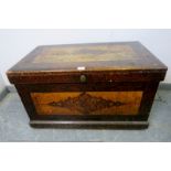 An antique pine flat top trunk, painted in the Continental style, the internal candle box with two
